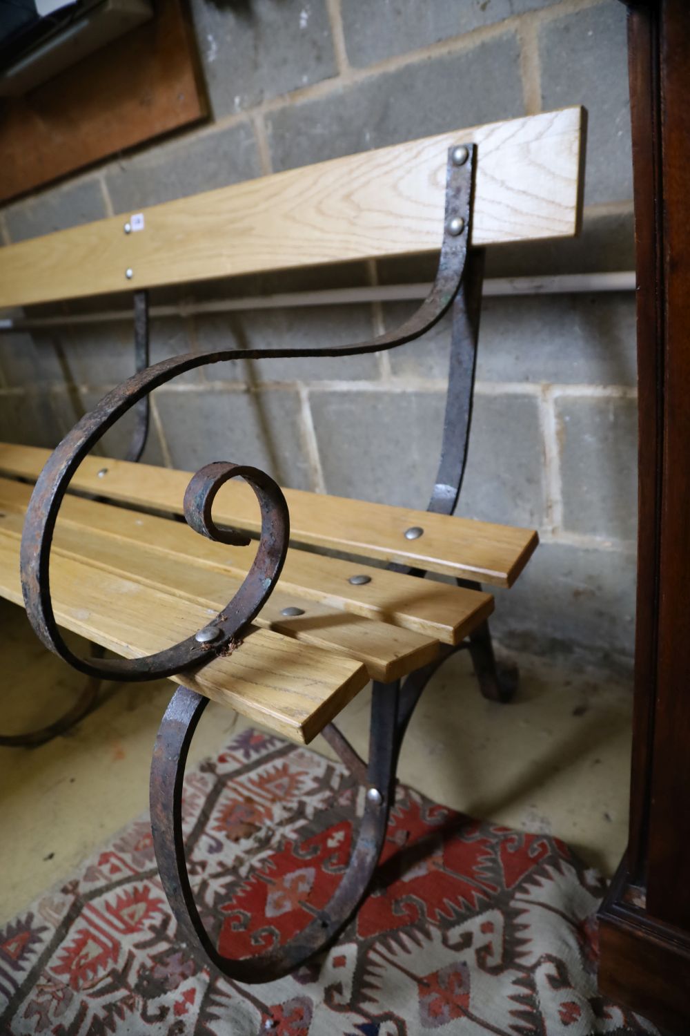 A Victorian wrought iron and ash garden bench with later slatted seat, length 155cm, depth 70cm, height 82cm